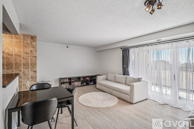 A living room with a black chair and a black table.