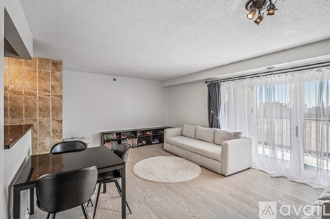 A living room with a black chair and a black table.