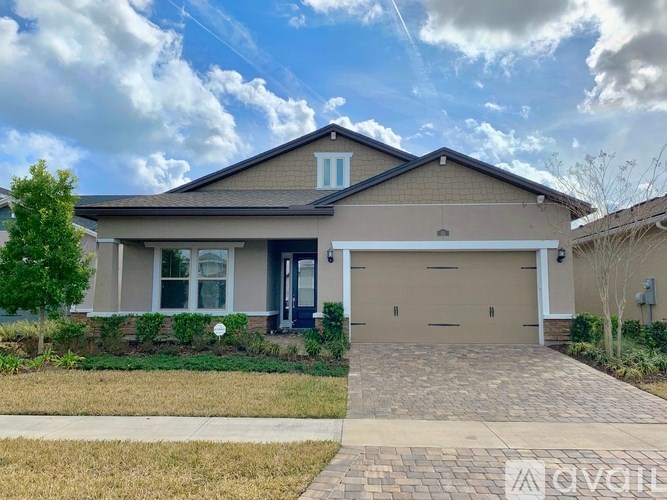A two-story house with a garage and a driveway.