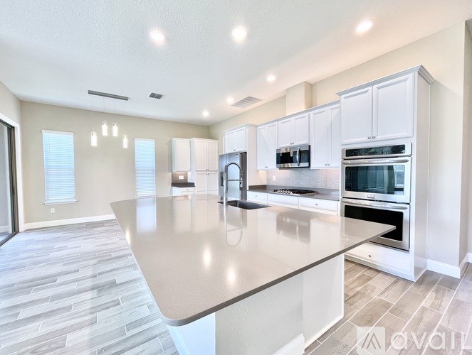 A modern kitchen with a large island in the middle.