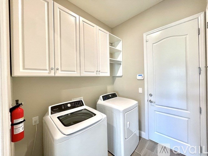 A laundry room with a washer and dryer.