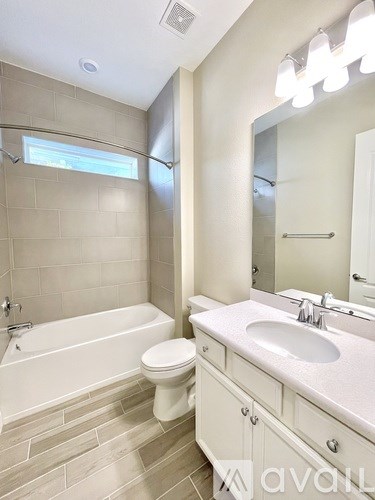 A white bathroom with a sink, toilet and tub.