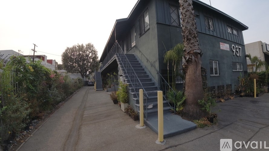 A house with the number 937 on it has a driveway leading to the front door.