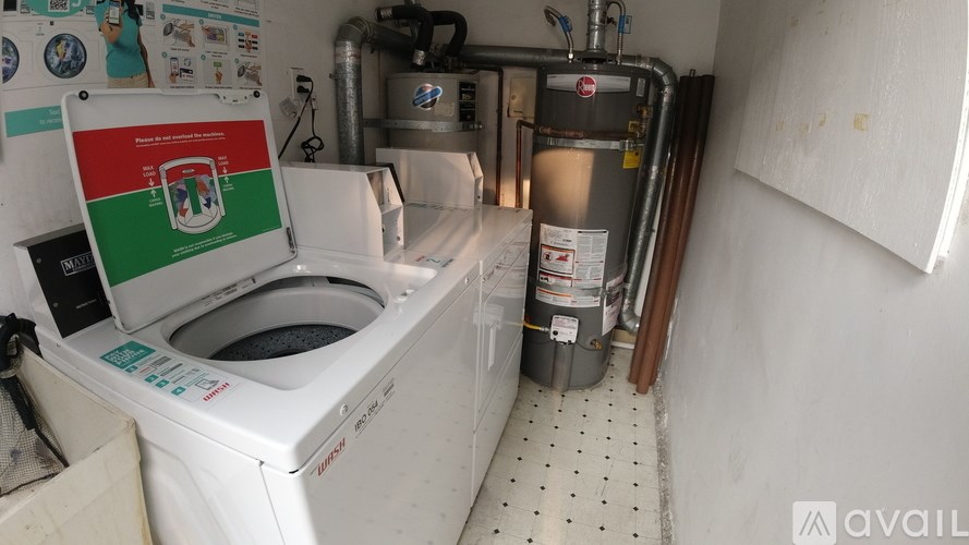 A white washing machine with a green and red sign on it.