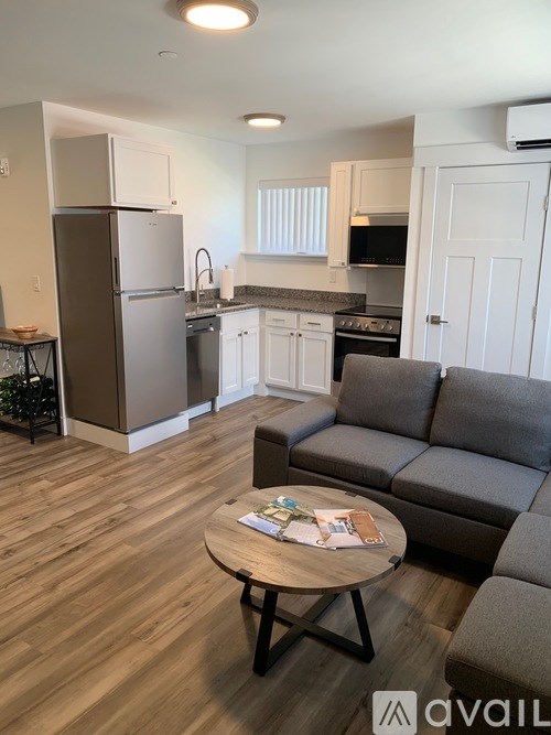 A kitchen with a refrigerator, oven, and microwave.
