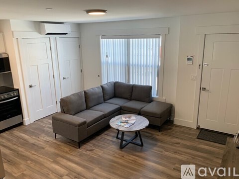 A living room with a grey sofa and a coffee table.