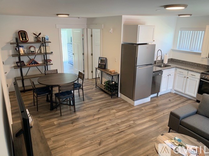 A kitchen with a table and chairs in the middle of the room.