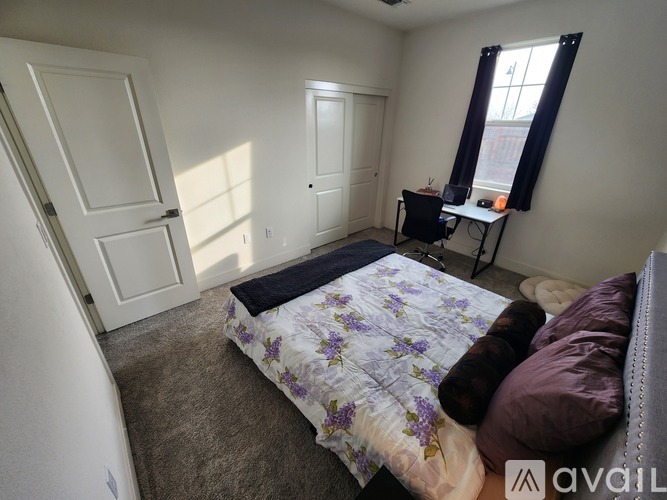 A living room with a grey couch and a wooden floor.