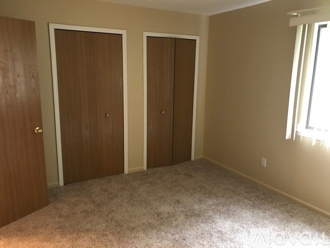 A room with two doors and a window.