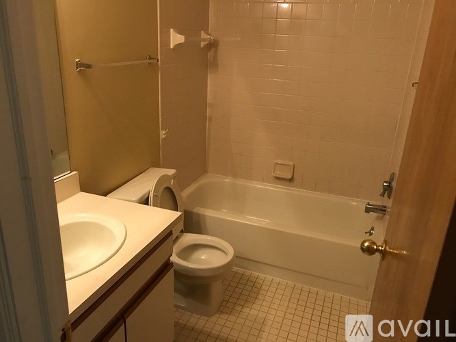 A bathroom with a toilet, sink, and bathtub.