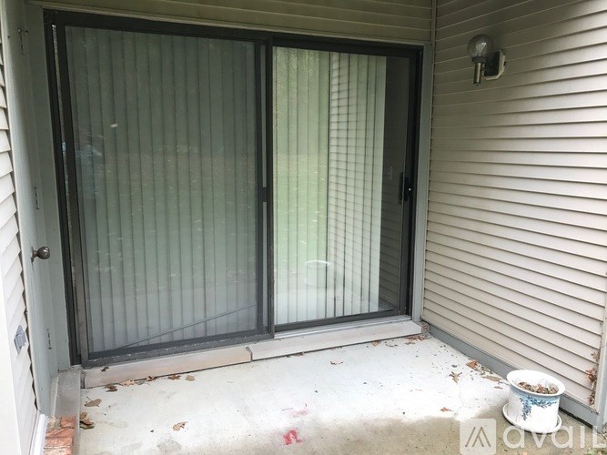 A glass door with a handle and a wall sconce.