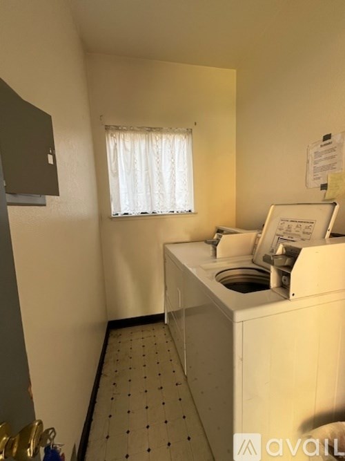A small laundry room with a washer and dryer.