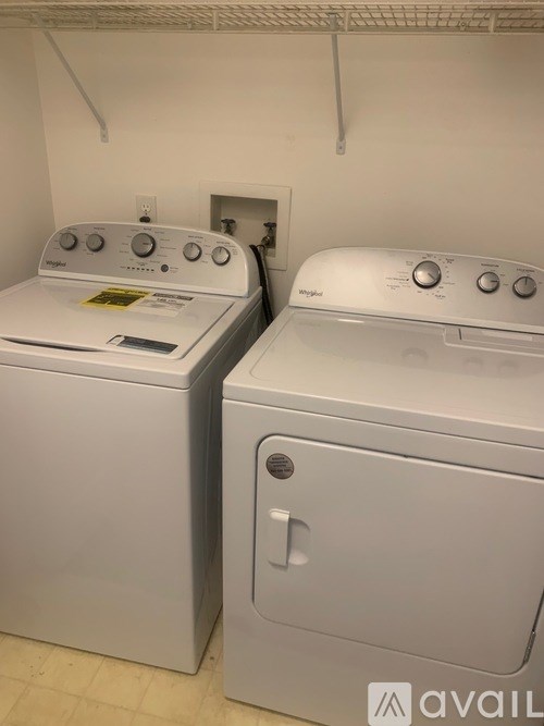 Two front loading washing machines in a laundry room.