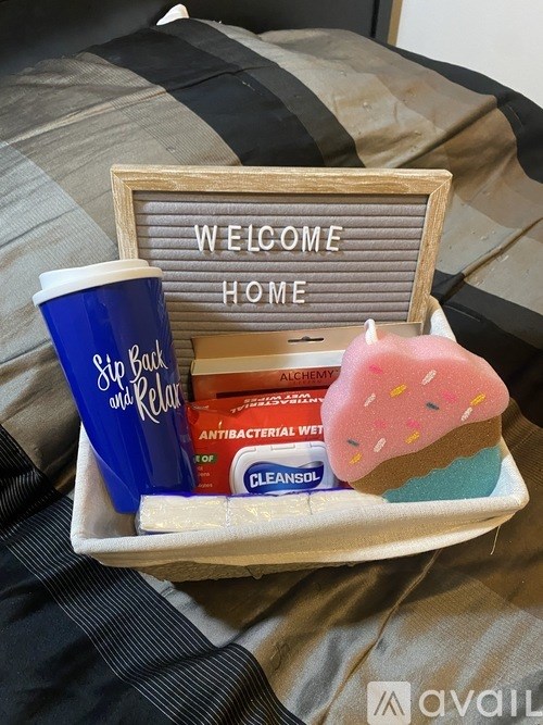 A tray with a welcome home sign, a coffee mug, and some toiletries.