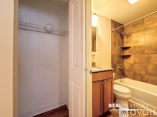 A bathroom with a toilet, sink, and a bathtub.