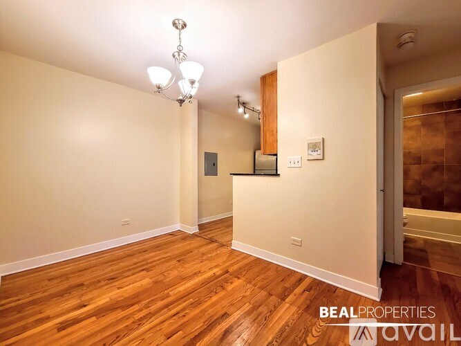 A room with wooden floors and a chandelier.