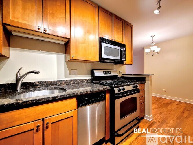 A kitchen with wooden cabinets and black appliances.