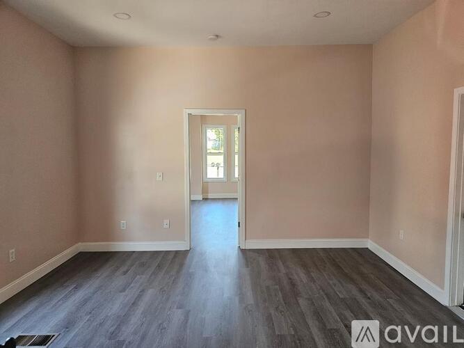 A room with a doorway leading to another room.