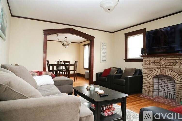 A living room with a fireplace and a television.