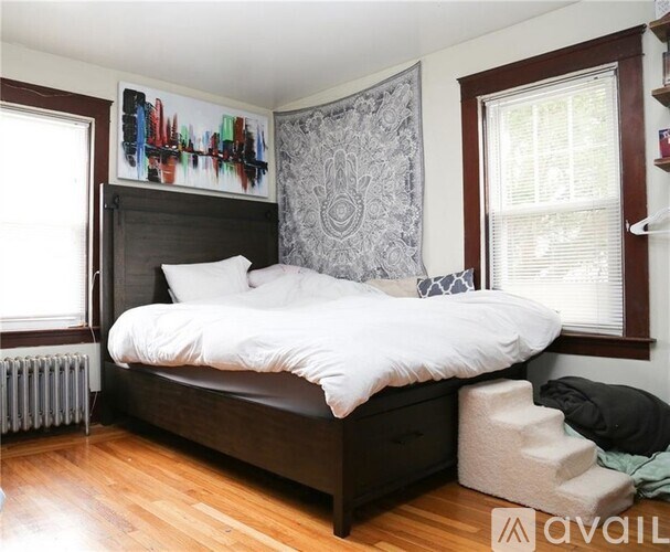 A bedroom with a large bed and a window.