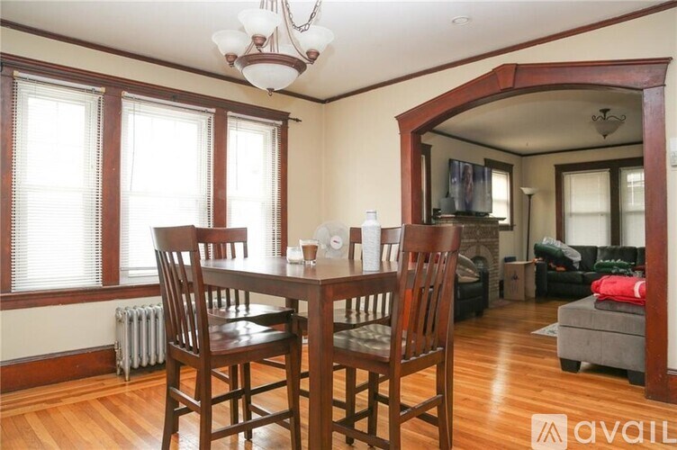 A dining room with a wooden table and chairs.