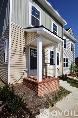 A house with a grey siding and a black door.