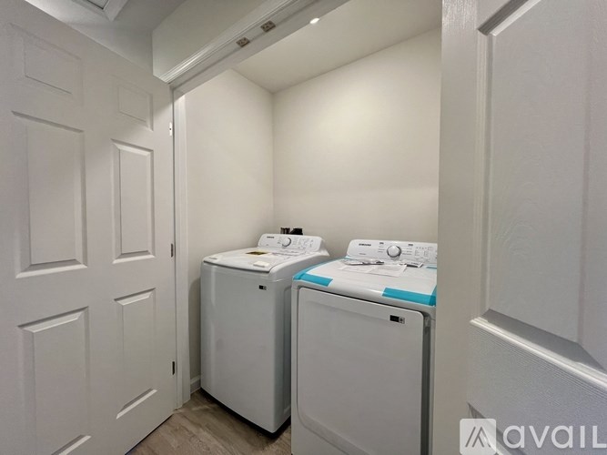 A small laundry room with a washer and dryer.