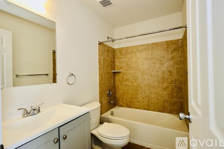 A bathroom with a toilet, sink, and bathtub.