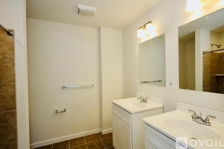 A bathroom with a white sink and a white toilet.