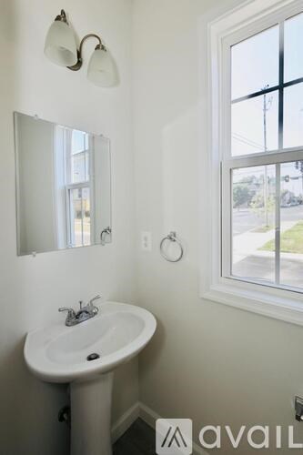 A white bathroom sink with a mirror above it.