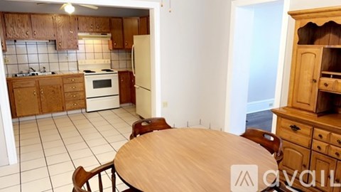 A kitchen with wooden cabinets and a table.