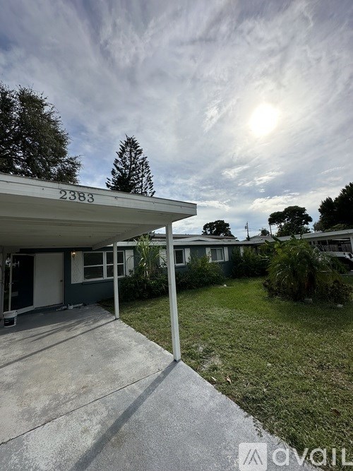 A house numbered 2383 with a driveway leading to the front door.