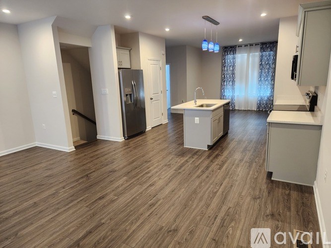 A kitchen with a sink, refrigerator, and cabinets is available for rent.