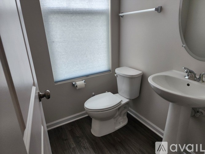 A white toilet sits next to a sink in a bathroom.