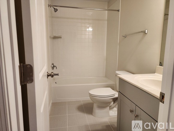 A bathroom with a toilet, sink, and shower.
