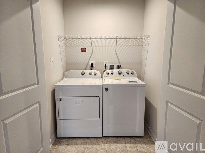 A white washer and dryer in a small laundry room.