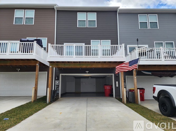 A two-story house with a garage and a balcony.