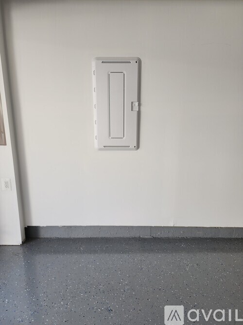 A white door with a handle is mounted on a white wall.