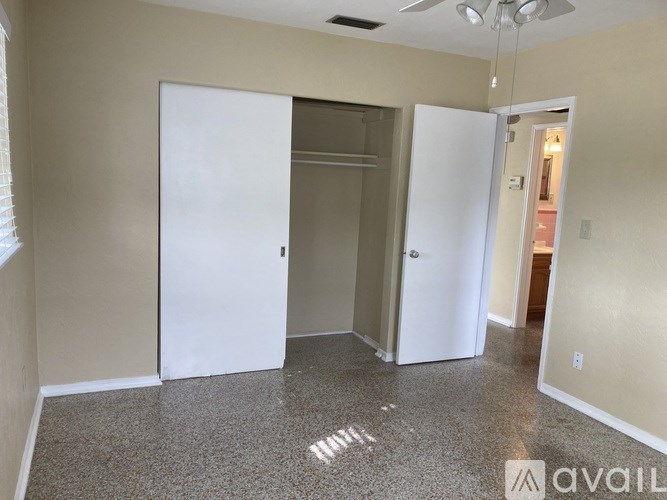 A room with a white door and a white wall.