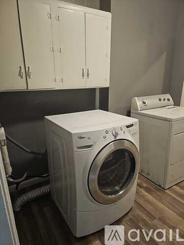 A small blue house with a white door and a window.