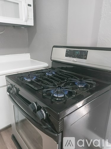 A modern stove with a digital display is in a kitchen.