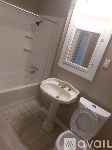 A white sink and toilet in a small bathroom.