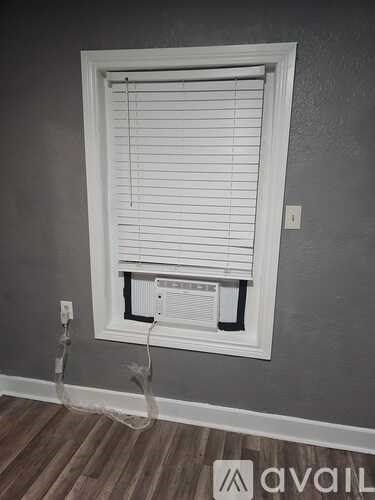 A white sink with a chrome faucet and a drain in the middle.