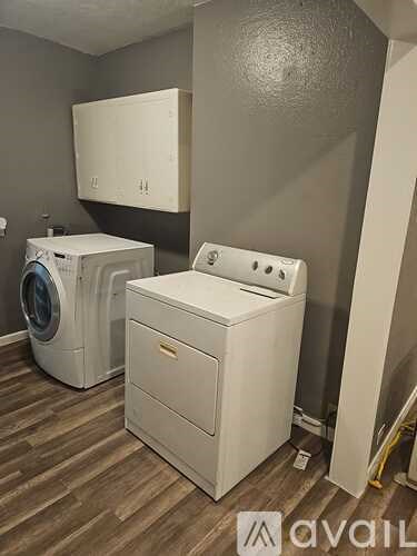 A washer and dryer are in a laundry room.