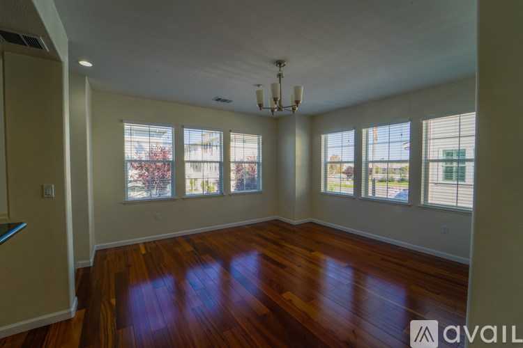 A room with wooden floors and a chandelier.