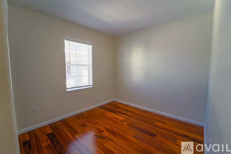 A room with wooden floors and a window.