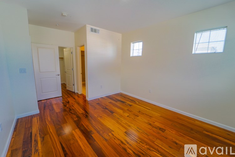 A room with wooden floors and white walls.