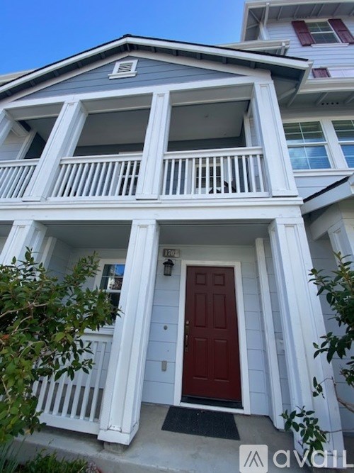 A house with a red door and white railings.