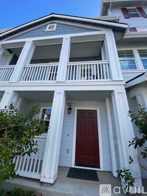 A house with a red door and white railings.