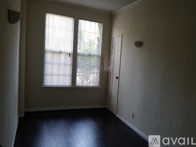 A room with a large window and a closed door.